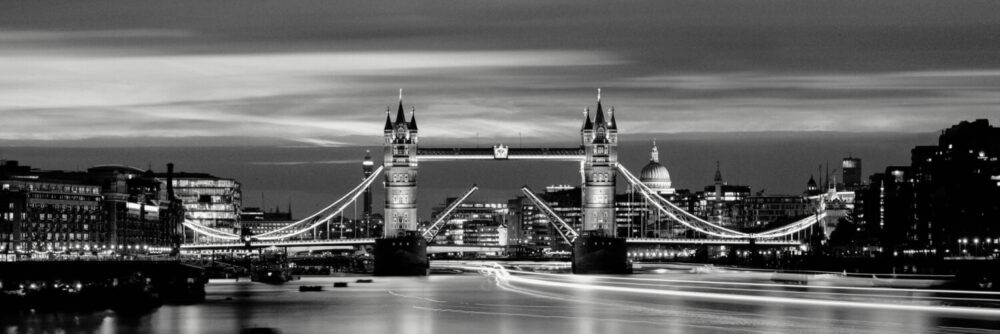 The Tower Bridge raised at night in london city