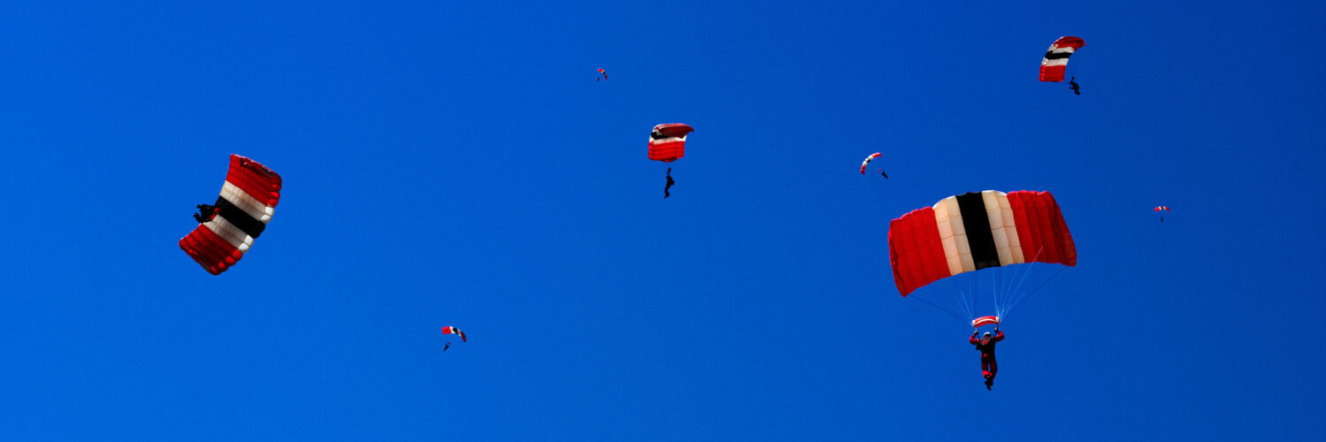 Sky divers with their parachutes open