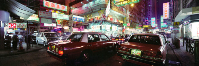 Hong Kong taxis on a neon lit street in mong kok