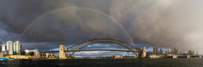 A Rainbow over Sydney harbour with the city in the backdrop