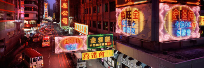 right Neon signs light up a street in Mong Kok Hong Kong