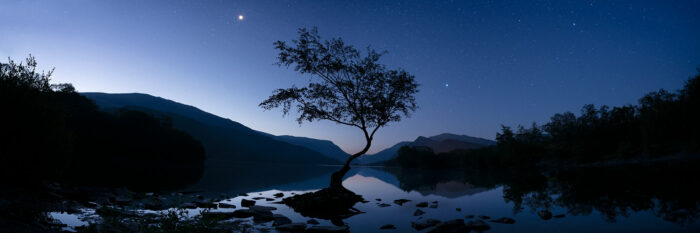 Snowdonia national park lake at night with the moon and stars