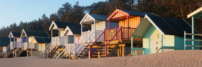 Colourful Beach huts at dawn on an English beach
