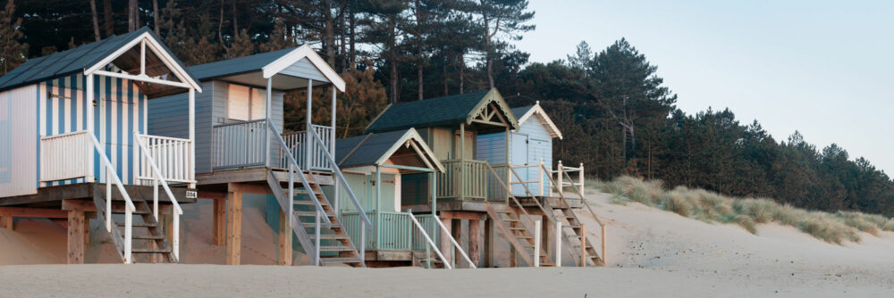 Colourful Beach huts at dawn on an English beach