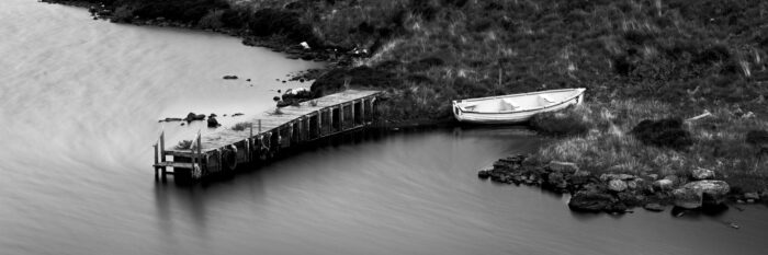 B&W boat and Scottish jetty on a loch