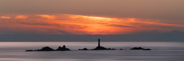 Lighthouse at sunset on the Cornish coast