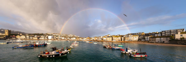 St Ives harbour and fishing boats with a rainbow on the Cornwall coast