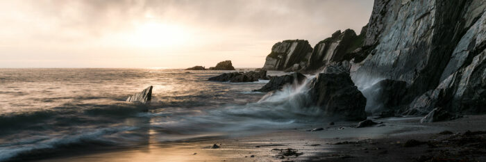 Panorama of the dramatic Ayrmer Cove at sunset along the southwest coast path in Devon
