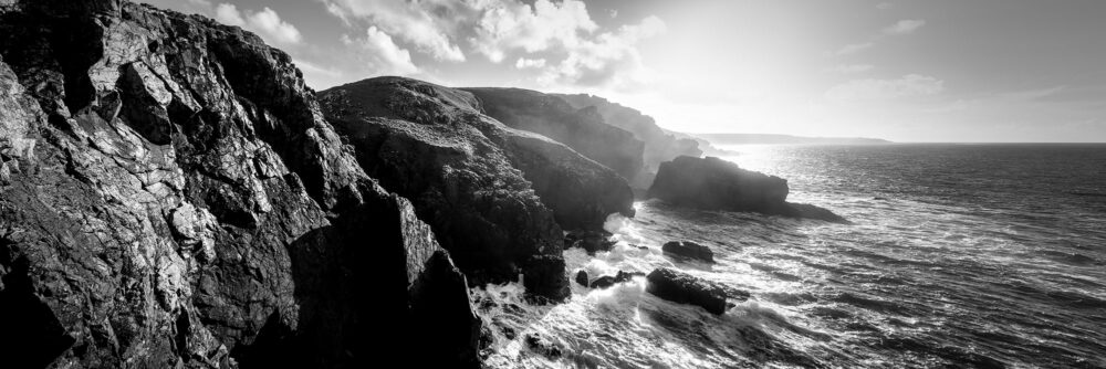 Panorama of dramatic stormy Cornwall coast in b&w