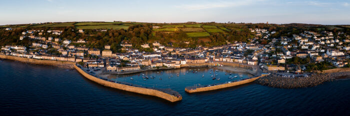 aerial panorama of mouse hole harbour and fishing village at sunrise in Cornwall