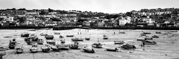 Panorama of stranded fishing boats in St Ives Harbour b&w