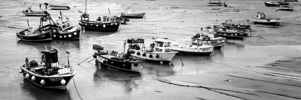 Cornish fishing boats at low tide in St Ives b&w