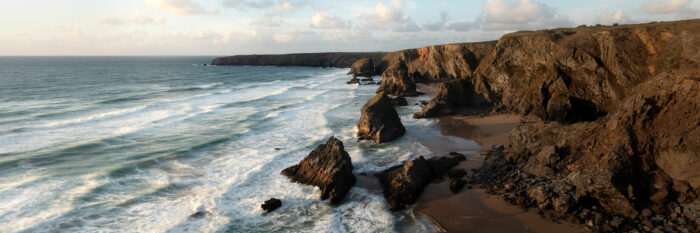 Panorama of bedruthan steps beach at sunset in Cornwall along the south west coast path