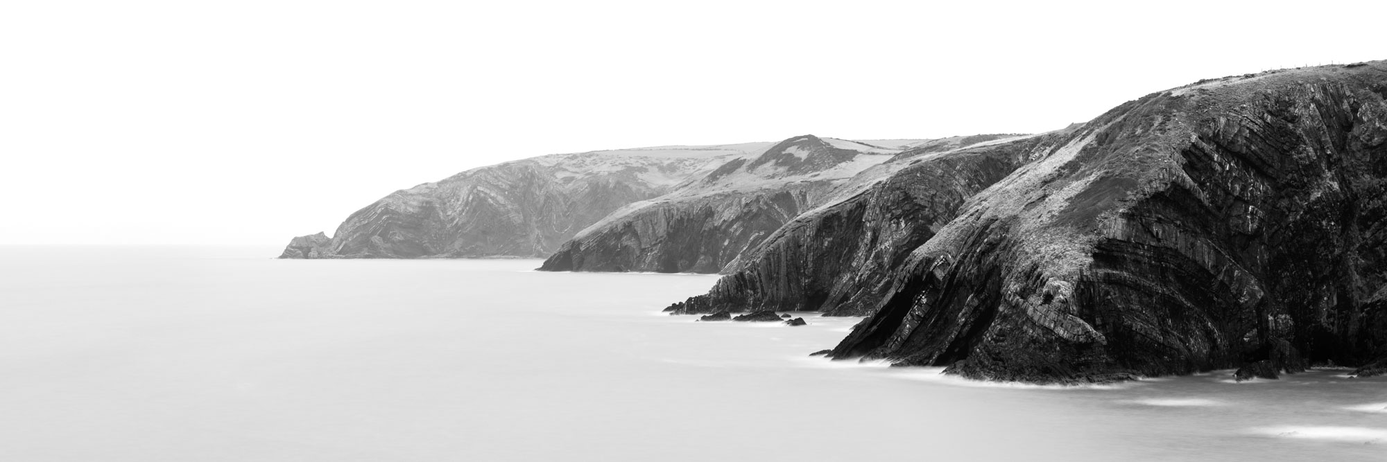 Black and white panorama of Ceibwr Bay in Pembrokeshire