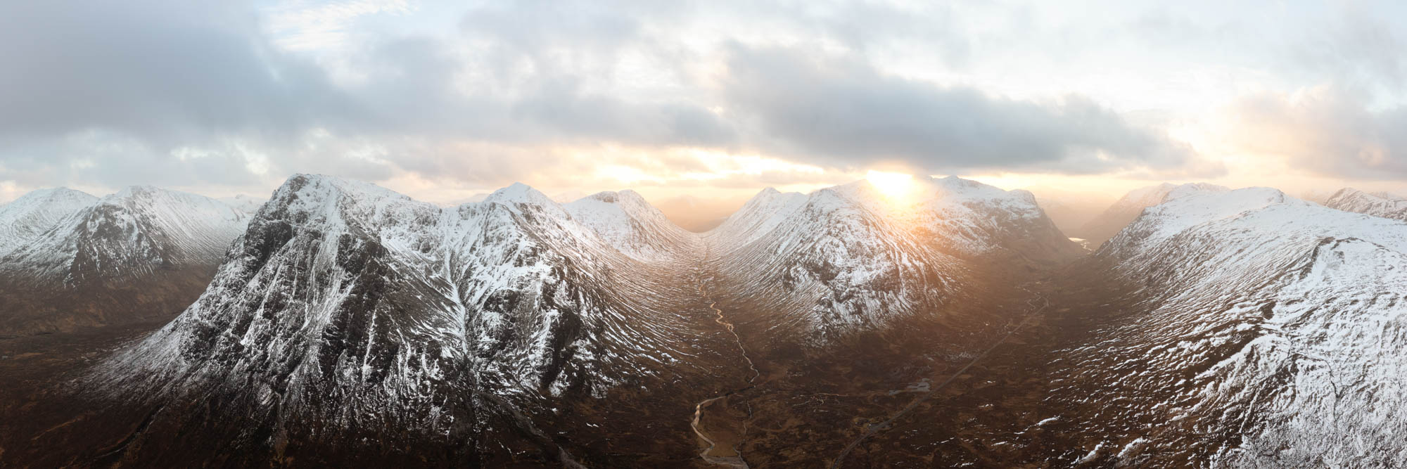 Aerial Panorama of Glencoe valley and Buachaille Etive Mòr Stob Dearg in winter in the Scottish highlands