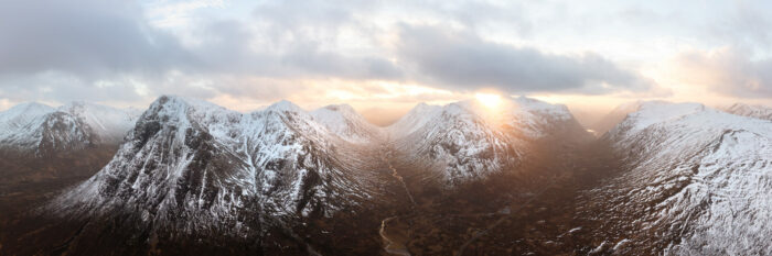 Aerial Panorama of Glencoe valley and Buachaille Etive Mòr Stob Dearg in winter in the Scottish highlands