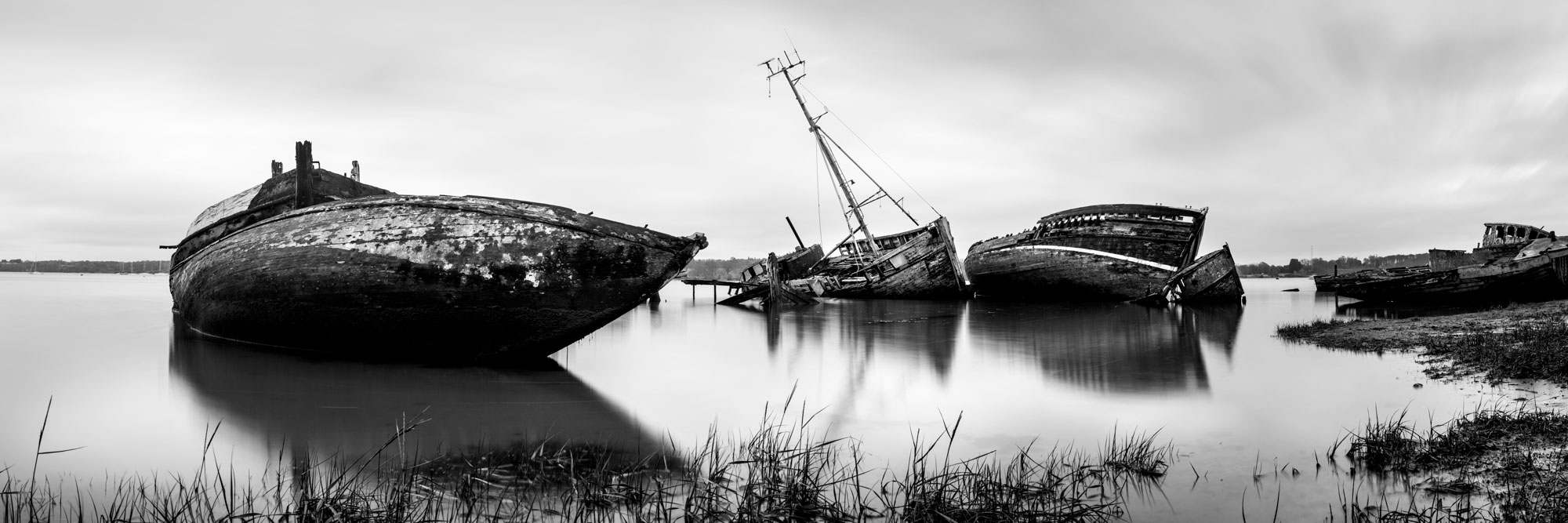 Panorama of old fishing boats in Pin Mill Suffolk coast