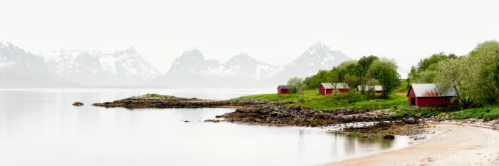 Panorama of red Hadseløya Boat houses with the Lofoten island mountains behind