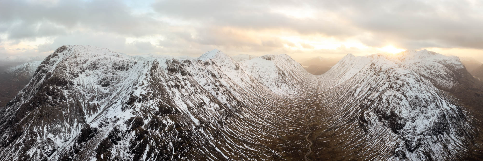 Aerial Panorama of Lairig Gartain valley and Buachaille Etive Mòr Stob Dearg in winter in the Scottish highlands