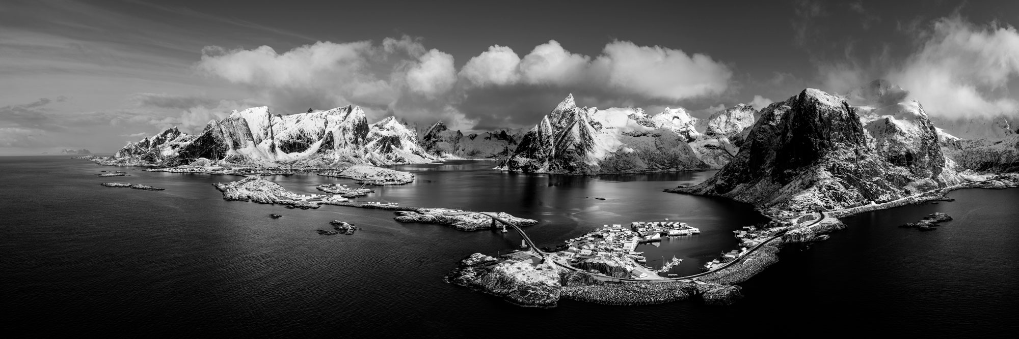 Aerial Panorama of the Fishing villages and mountains of Hamnøy, Reine and Sakrisoy in the Lofoten Islands in black and white