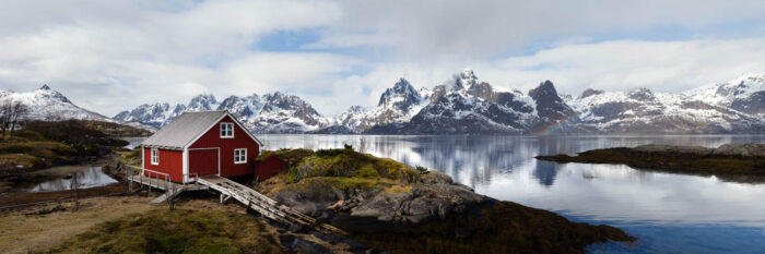 Panorama of a red Boat house in the Lofoten Islands with Lofoten Islands Red Boat house and Trakta mountains and Fjord Austvågøya island
