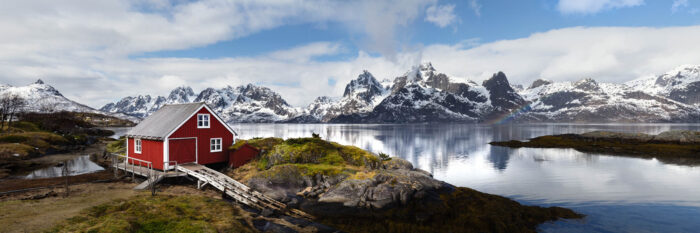 Panorama of a red Boat house in the Lofoten Islands with Lofoten Islands Red Boat house and Trakta mountains and Fjord Austvågøya island