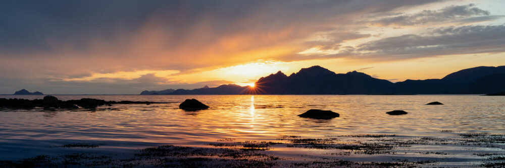 Panorama of the midnight sun with the islands of Vesterålen on the Vestvagoya coast