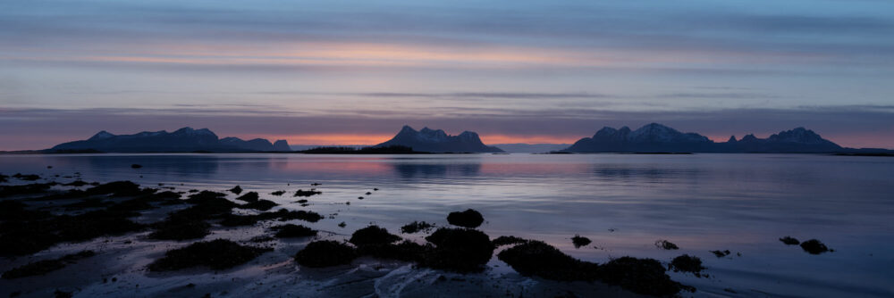 Panorama of Sunset on a beach in Nordland with the isles of Lundøya Engeløya and Skutvika in the distance