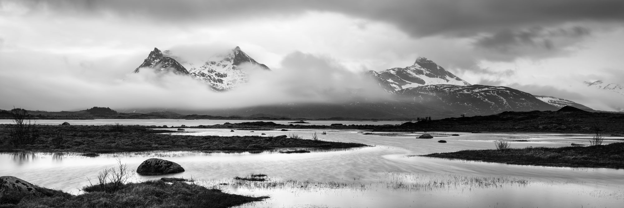 Monochrome panorama of the Lakes and Fjords of the Lofoten islands on a stormy day at the Gimsøymyrene nature preserve