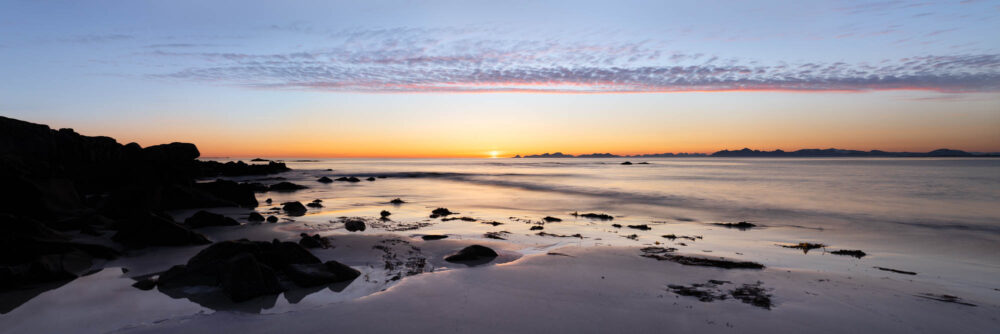 Panorama of Vinje Beach on Gimsoya Island during the midnight sun with the Vesterålen Islands behind in the Lofoten Islands