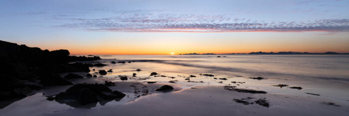 Panorama of Vinje Beach on Gimsoya Island during the midnight sun with the Vestero Islands behind in the Lofoten Islands