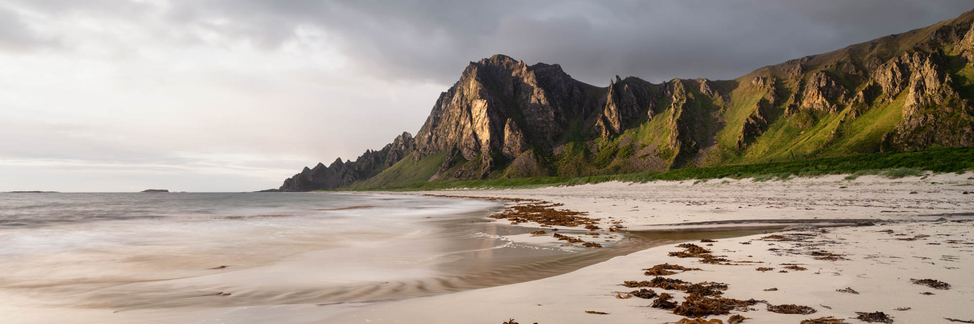 Panorama of a windswept beach on Andøya Island with Røyken mountains behind in Vesterålen