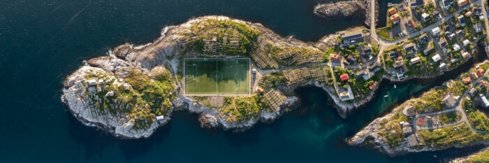 Aerial panorama of Henningsvær fishing village football stadium from above in the Lofoten islands