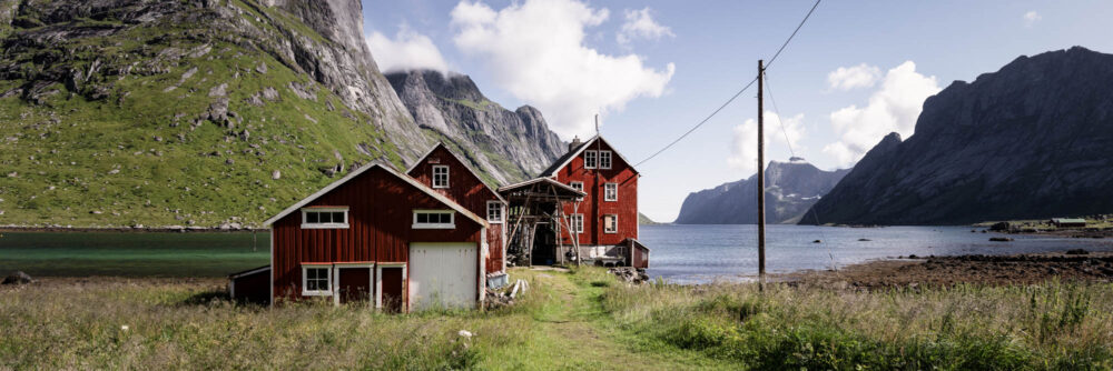 Panorama of a Norwegian red barn cabin in Kjerkfjorden in Moskenesoya in the Lofoten Islands