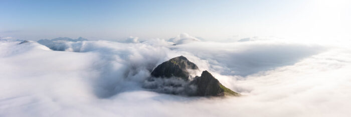Aerial panorama of a mountain amongst a cloud inversion in the Lofoten Islands in Norway in the arctic circle