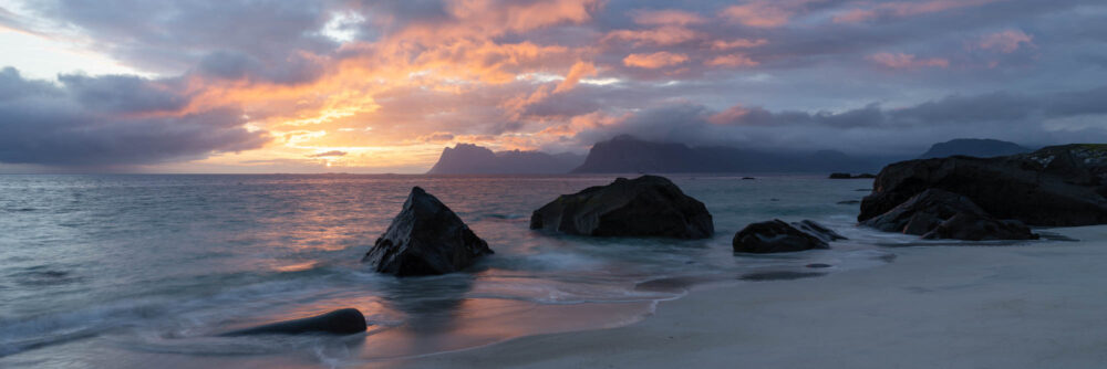 Panorama of a beautiful sunrise on Myrland beach in the Lofoten Islands