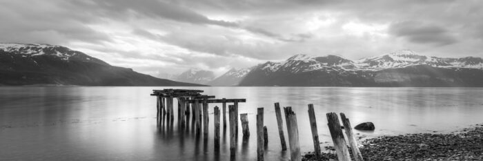 Panorama of an old worn pier in black and white in Troms go Finnmark