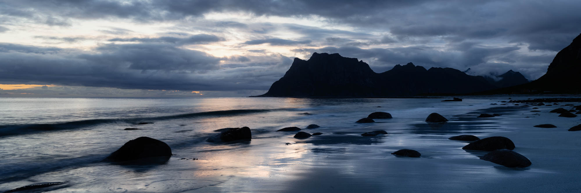 Panorama of a cinematic dark and moody beach in the Lofoten Islands at night