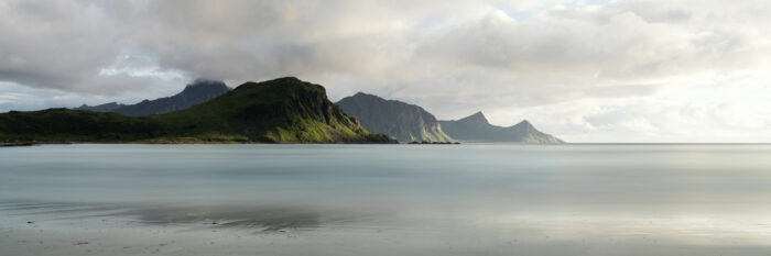 Panorama of the Moskenes mountains in summer from Vik beach in the Lofoten Islands