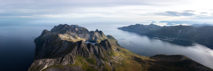 Aerial panorama of Insteps Kongen mountains along Øyfjorden on Senja Island in Norway