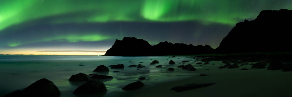 Panorama of the Northern Lights above Uttakleiv Beach in the Lofoten Islands