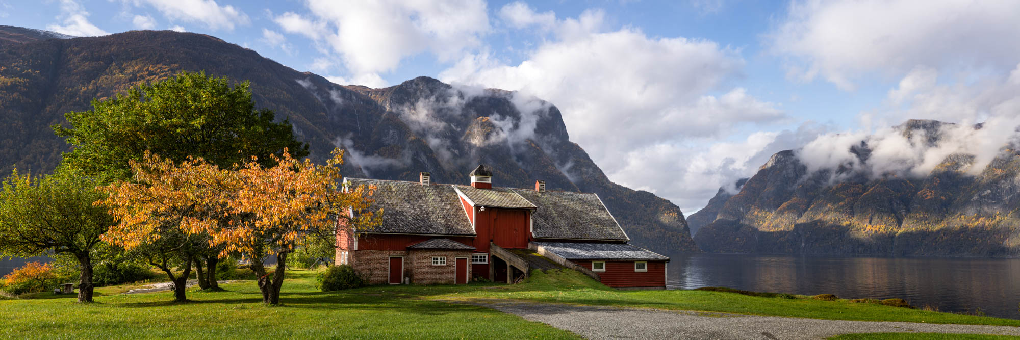 Panorama of a red barn on Aurlandsfjord in Norway