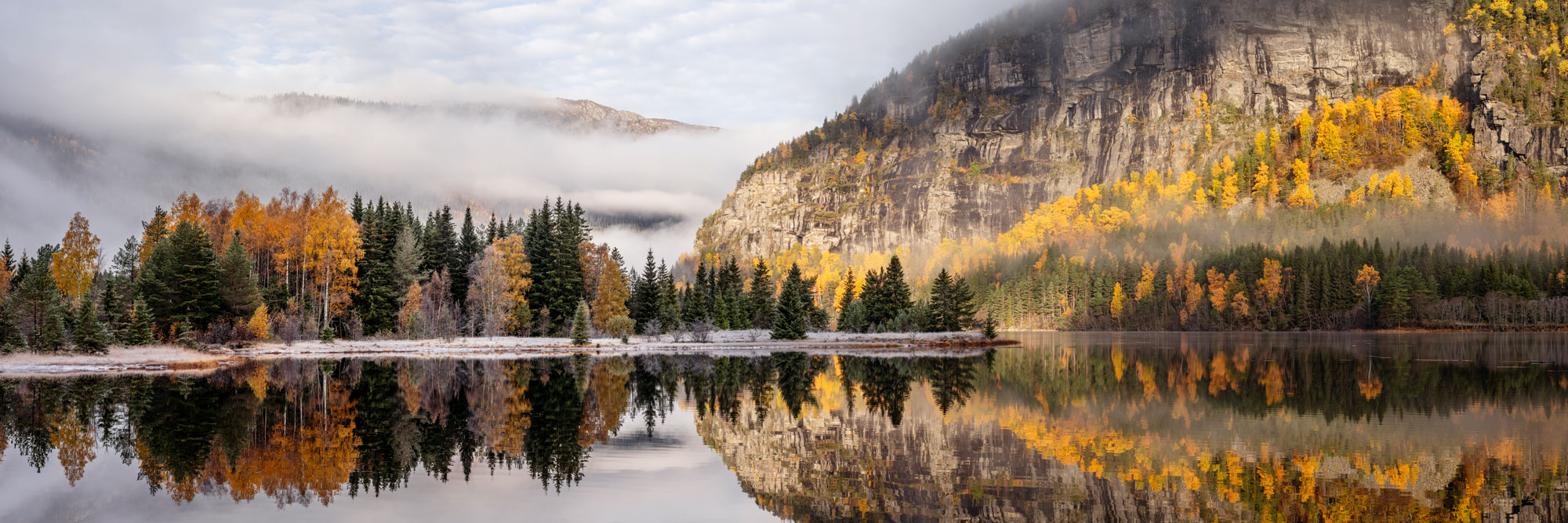 Panorama of the Otra river ishrouded in fog on an autumn morning in Norway