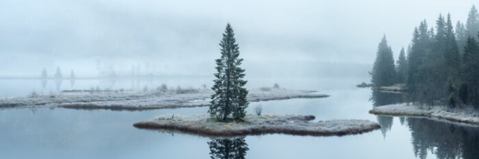 Panorama of the Otra River shrouded in mist on a frosty morning in Norway