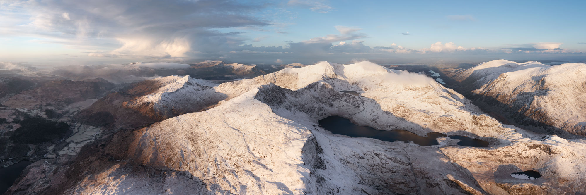 Aerial panorama of Snowdonia covered in snow in winter in Wales