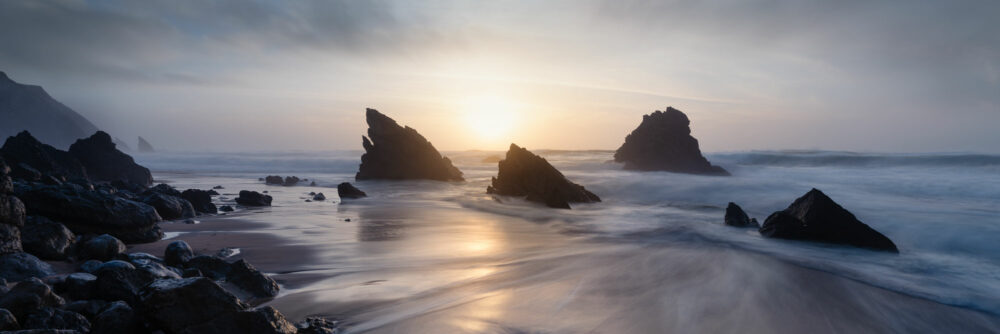 Panorama of Adraga beach at sunset in Portugal