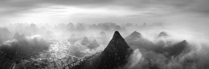 Black and white aerial art of the Karst mountains in Guilin covered in mist China