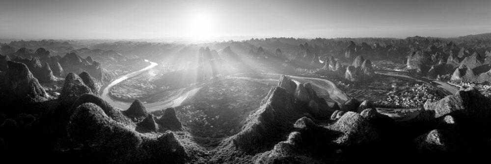 Black and white aerial panorama of the River Li winding through Karst mountains in Yangshuo, China