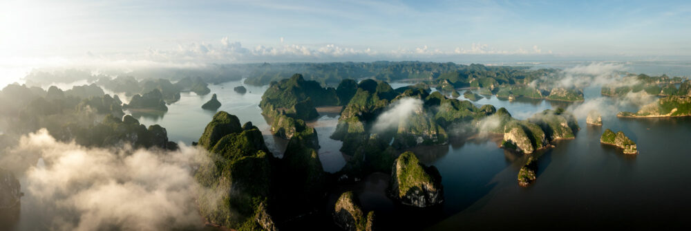 Aerial panorama above the clouds of Ha Long Bay and Car Ba Island in Vietnam