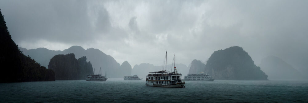 Moody Panorama of cruise ships on Ha long Bay during a storm in Vietnam